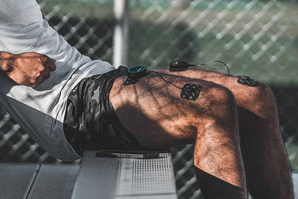 athlete using mini wireless on bleachers