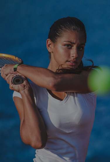 tennis player hitting tennis ball