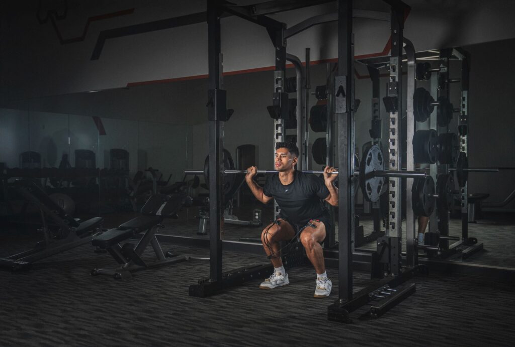 man lifting weights with Compex device